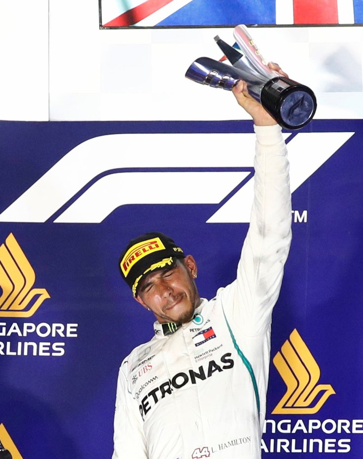 Formula One F1 - Singapore Grand Prix - Marina Bay Street Circuit, Singapore - September 16, 2018 Mercedes' Lewis Hamilton celebrates on theÊpodiumÊafter winning the race REUTERS/Edgar Su Formula One F1 - Singapore Grand Prix - Marina Bay Street Circuit, Singapore - September 16, 2018 Mercedes' Lewis Hamilton celebrates on theÊpodiumÊafter winning the race REUTERS/Edgar Su