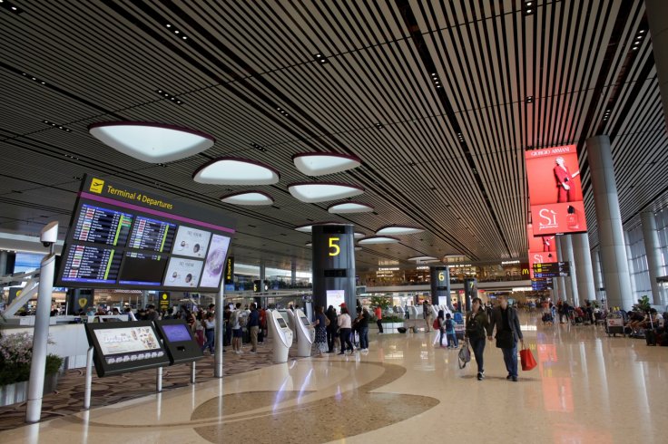 A couple walks through Changi airport's Terminal 4 in Singapore April 30, 2018. 