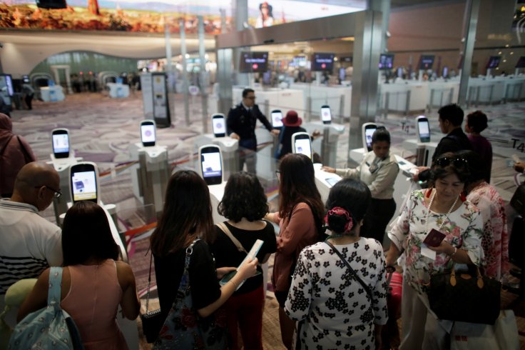 Passengers line-up at automated immigration control gates at Changi airport's Terminal 4 in Singapore April 30, 2018. Picture taken April 30, 2018. REUTERS/Thomas White