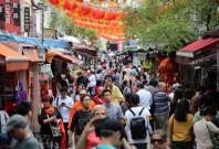 People walk through Chinatown in Singapore People walk through Chinatown in Singapore