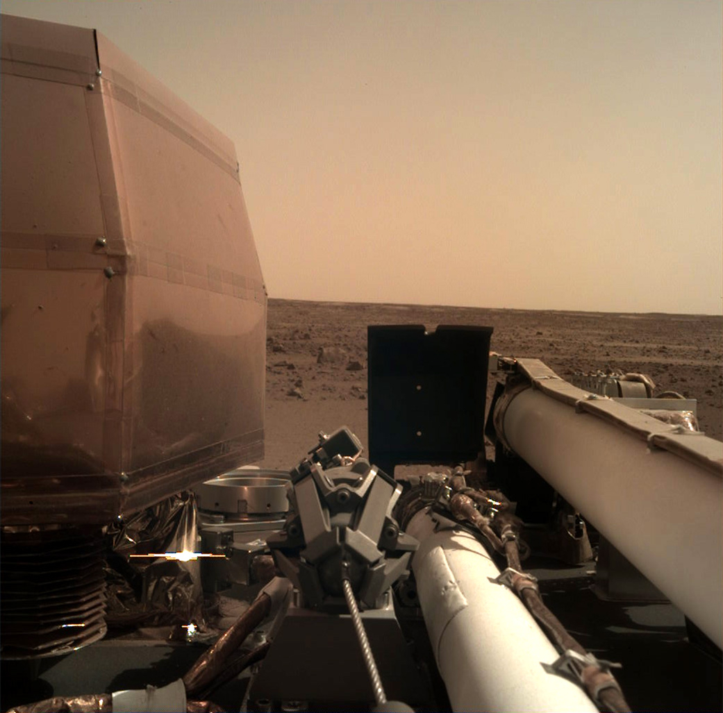 The Instrument Deployment Camera (IDC), located on the robotic arm of NASA's InSight lander, took this picture of the Martian surface on Nov. 26, 2018, the same day the spacecraft touched down on the Red Planet. The camera's transparent dust cover is stil