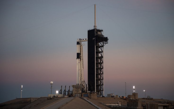 A SpaceX Falcon 9 rocket with the companyâ€™s Crew Dragon spacecraft onboard is seen after being raised into a vertical position on the launch pad at Launch Complex 39A as preparations continue for the Demo-1 mission, Feb. 28, 2019, at NASAâ€™s Kennedy Space 