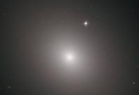 This fuzzy orb of light is a giant elliptical galaxy filled with an incredible 200 billion stars.