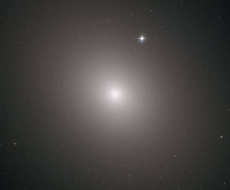 This fuzzy orb of light is a giant elliptical galaxy filled with an incredible 200 billion stars. This fuzzy orb of light is a giant elliptical galaxy filled with an incredible 200 billion stars.