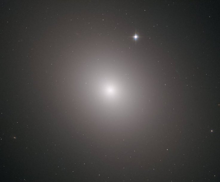 This fuzzy orb of light is a giant elliptical galaxy filled with an incredible 200 billion stars.