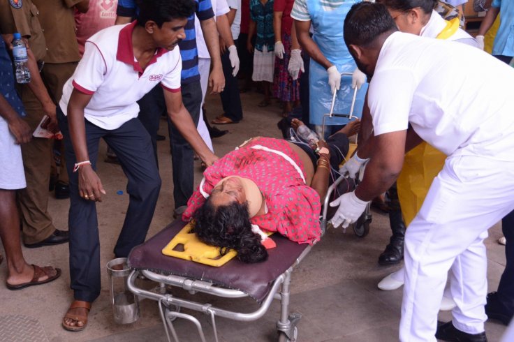  An injured woman is carried on a stretcher in a hospital in Negombo, north of Colombo, Sri Lanka, April 21, 2019. Sri Lankan Police said on Sunday that 13 people had been arrested over a series of blasts which killed 228 people across the island nation. 