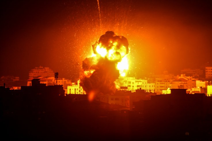 Photo taken on March 25, 2019 shows flame and smoke above buildings following an Israeli air strike in Gaza City. The Israeli army expanded air strikes on the Gaza Strip on Monday night after targeting Hamas security facilities in Gaza City, a local radio