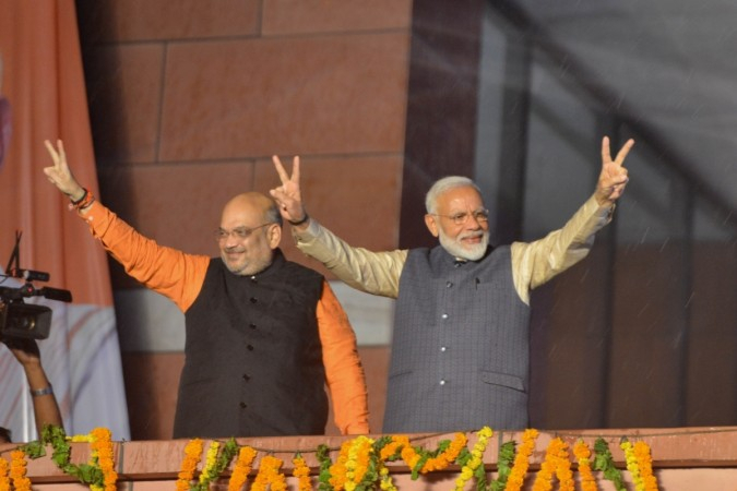 Prime Minister Narendra Modi and BJP chief Amit Shah wave at party workers during a party programme in New Delhi on May 23, 2019.