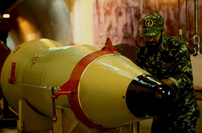 A member of the Iranian Revolutionary Guards checks a missile inside an underground depot in an undisclosed location, Iran, in this handout photo released by the official website of Islamic Revolutionary Guard Corps (IRGC) on March 8, 2016