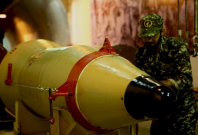 A member of the Iranian Revolutionary Guards checks a missile inside an underground depot in an undisclosed location, Iran, in this handout photo released by the official website of Islamic Revolutionary Guard Corps (IRGC) on March 8, 2016