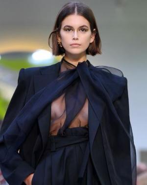 Kaia Gerber in a black sheer blouse