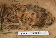 Excavations at the ancient Egyptian city of Amarna uncovered the skeleton of a woman in her 20s who was buried wearing a cone-shaped cap that likely held spiritual significance, researchers say.