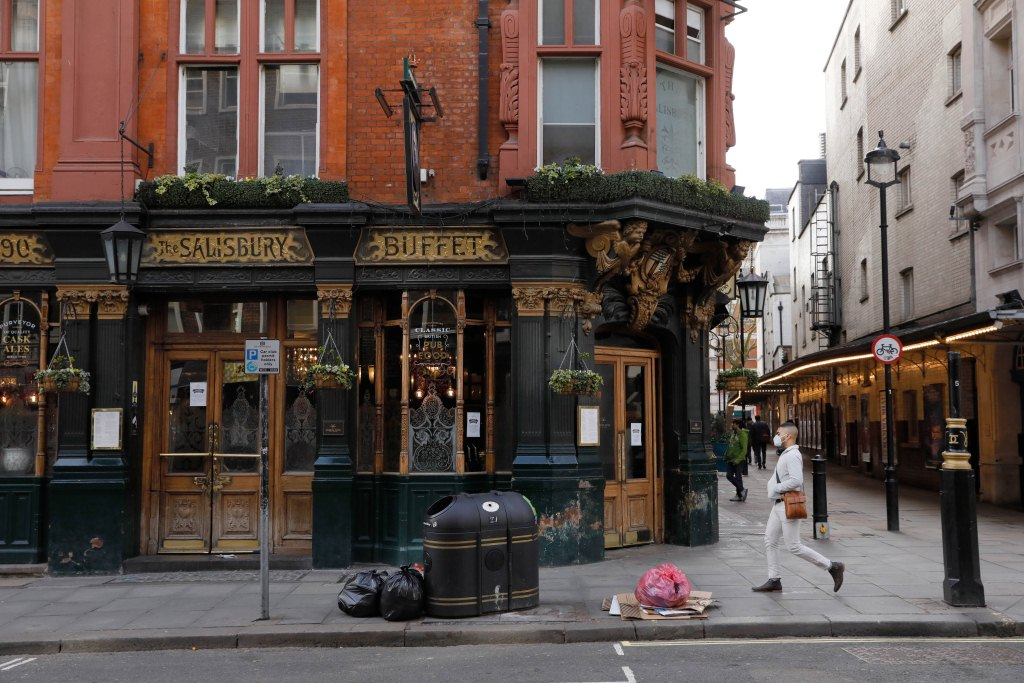 A man walks past a closed pub