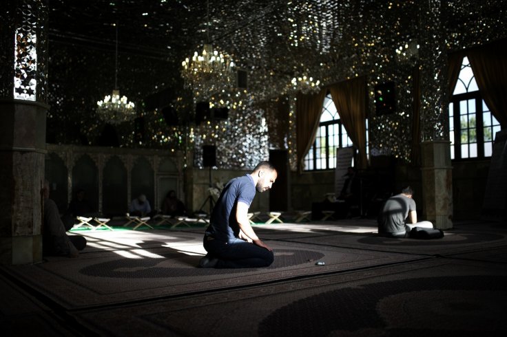 Iranian muslims pray before breaking Fast