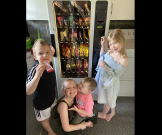 Kids get snacks from vending machine