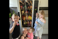 Kids get snacks from vending machine Kids get snacks from vending machine