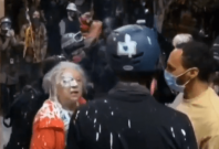 Protesters splash paint on Woman Protesters splash paint on Woman