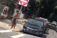 woman throws bottle at black jogger woman throws bottle at black jogger