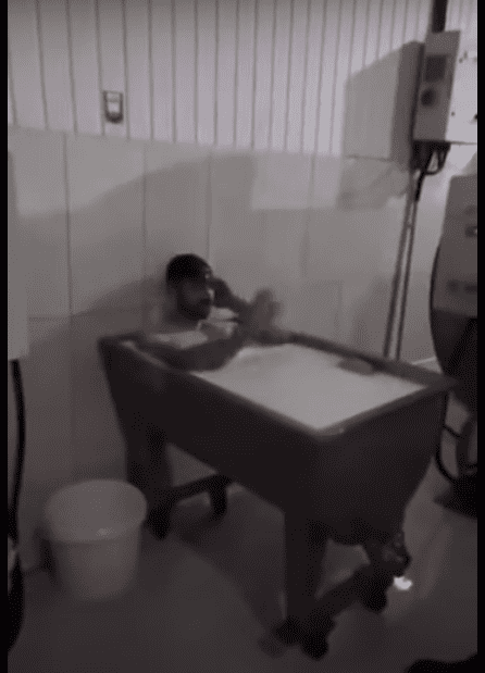 Man taking bath at milk factory