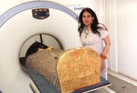 Dr Sahar Saleem placing the mummy in the CT scanner