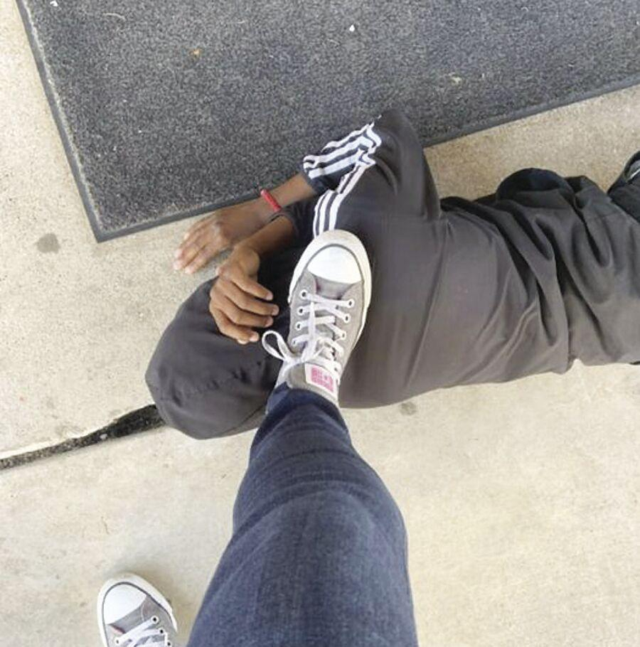 Teacher keeps foot on black students neck