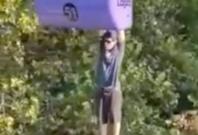 Man hanging form cable car Man hanging form cable car