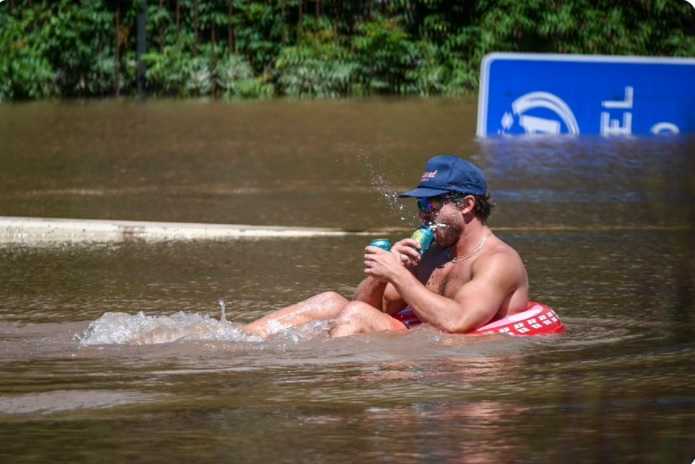 Man attempted to float along the floodwaters