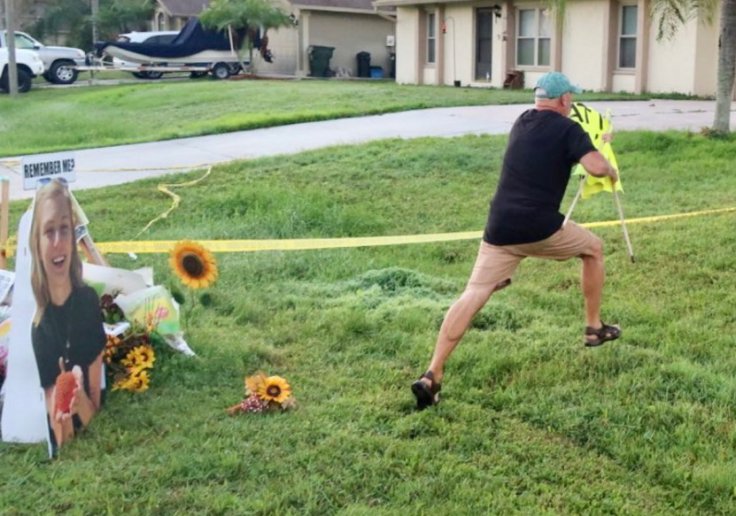 Chris Laundrie ripping down Gabby Petito sign