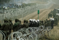 Polish soldiers and police watch migrants at the Poland/Belarus border near Kuznica, Poland Polish soldiers and police watch migrants at the Poland/Belarus border near Kuznica, Poland