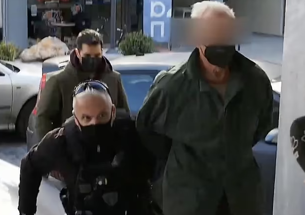 The killer (extreme right) being escorted into a police station by officers on Wednesday The killer (extreme right) being escorted into a police station by officers on Wednesday