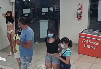 Footage showing woman trying to use to her dress as a mask