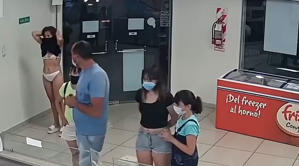 Footage showing woman trying to use to her dress as a mask