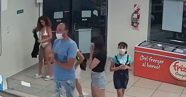 Footage showing woman trying to use her dress as a mask