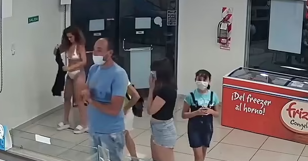 Footage showing woman trying to use her dress as a mask Footage showing woman trying to use her dress as a mask