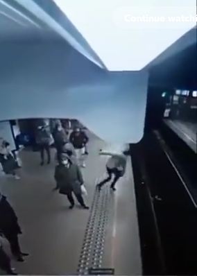 Screen grab of the video showing the woman falling onto the tracks Screen grab of the video showing the woman falling onto the tracks