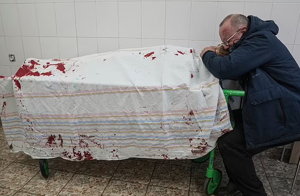 Iliya's father, Serhii cradled his lifeless body and sobbed uncontrollably Iliya's father, Serhii cradled his lifeless body and sobbed uncontrollably