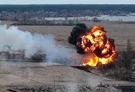 A Russian aircraft bursting into flames after being shot down by Ukrainians near Kyiv