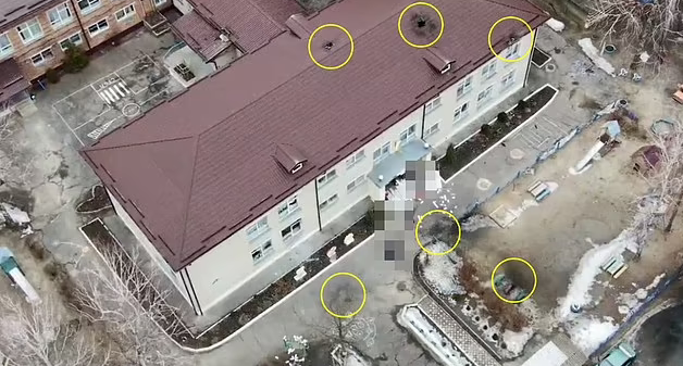  Picture of the aftermath of the attack showed bodies strewn around the entrance at the kindergarten in Okhtyrka