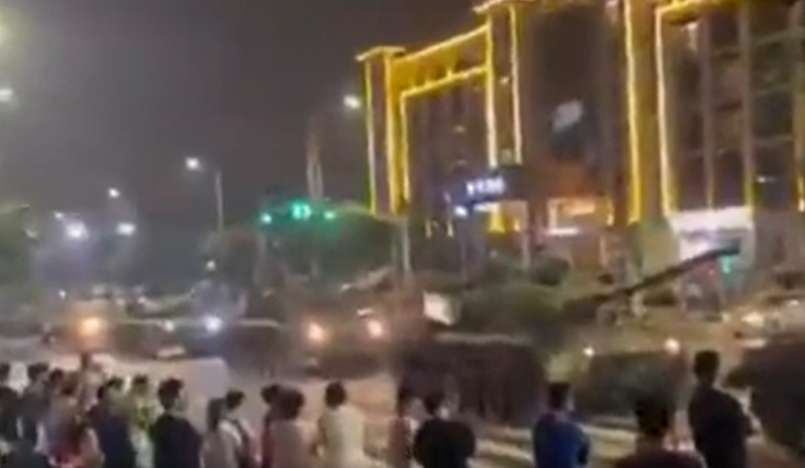  A long queue of tanks preventing people from entering a bank in China.