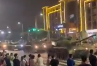  A long queue of tanks preventing people from entering a bank in China.