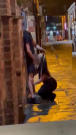 Woman performing oral sex act on a man in public
