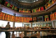 Investors monitor stock market prices in Kuala Lumpur