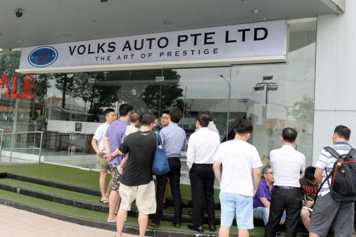 People gathering outside Volks Auto. Former employee Koh Chek Seng was charged with conspiring to commit criminal breach of trust. Photo: ST FILE