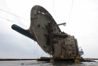 The sunken ferry Sewol sits on a semi-submersible ship during its salvage operations at the sea off Jindo, South Korea, in this handout picture provided by the Ministry of Oceans and Fisheries