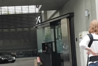 Four-year old girl talks to the guard of the YG Entertainment building