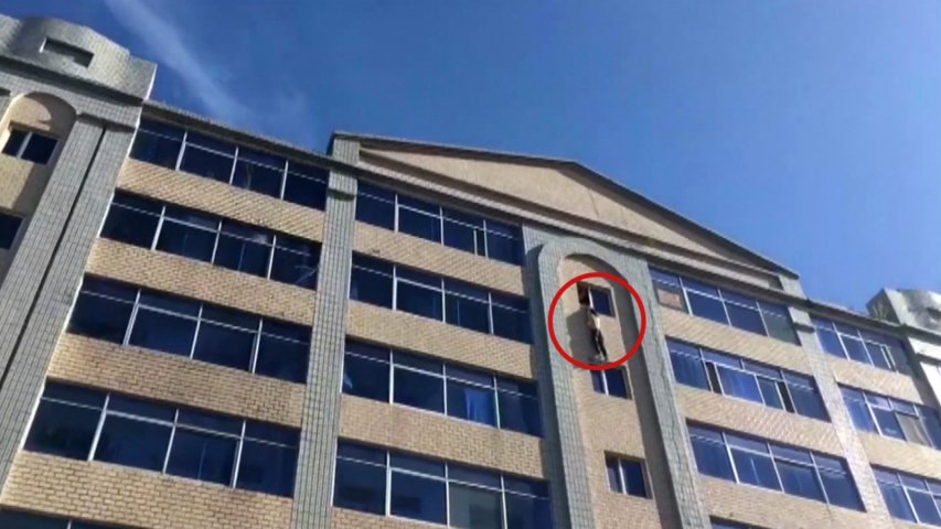 Watch as firefighters stop man from jumping off building