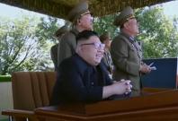 Watch a childlike Kim Jong-un chuckle at North Korean military display