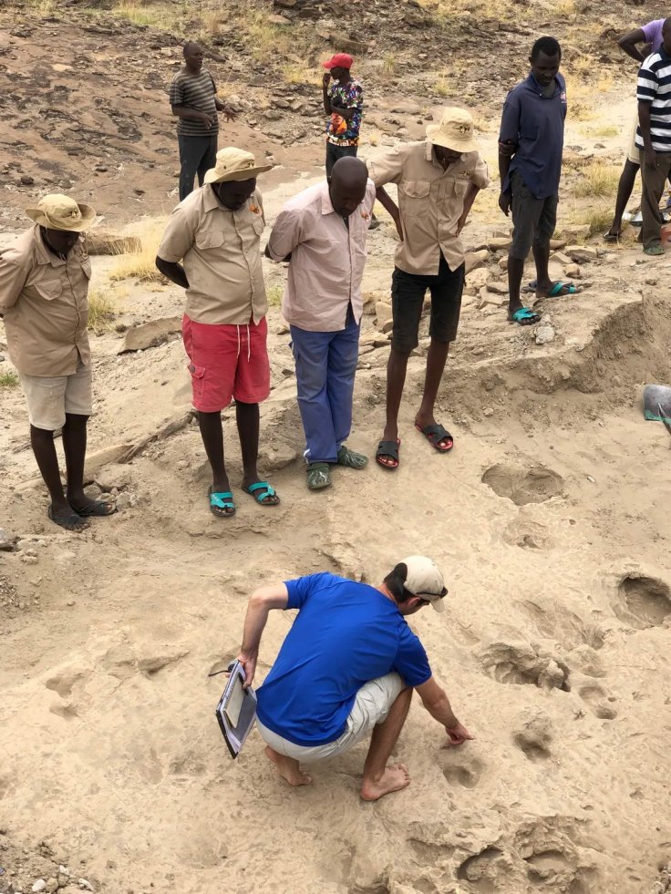 Study lead Kevin Hatala, an associate professor of biology at Chatham University in Pittsburgh, and an associate researcher at the Max Planck Institute for Evolutionary Anthropology in Leipzig, Germany, pointing out footprints of hominins among deeper hip