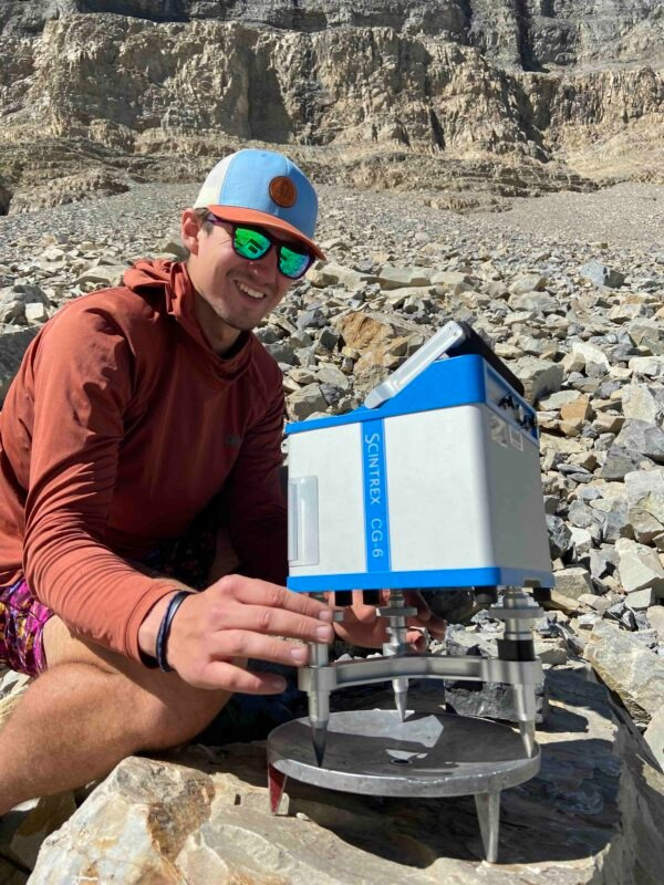Geology graduate student Bronson Cvijanovich operates a gravimeter while taking measurements of the Mount Timpanogos rock glacier in 2024.