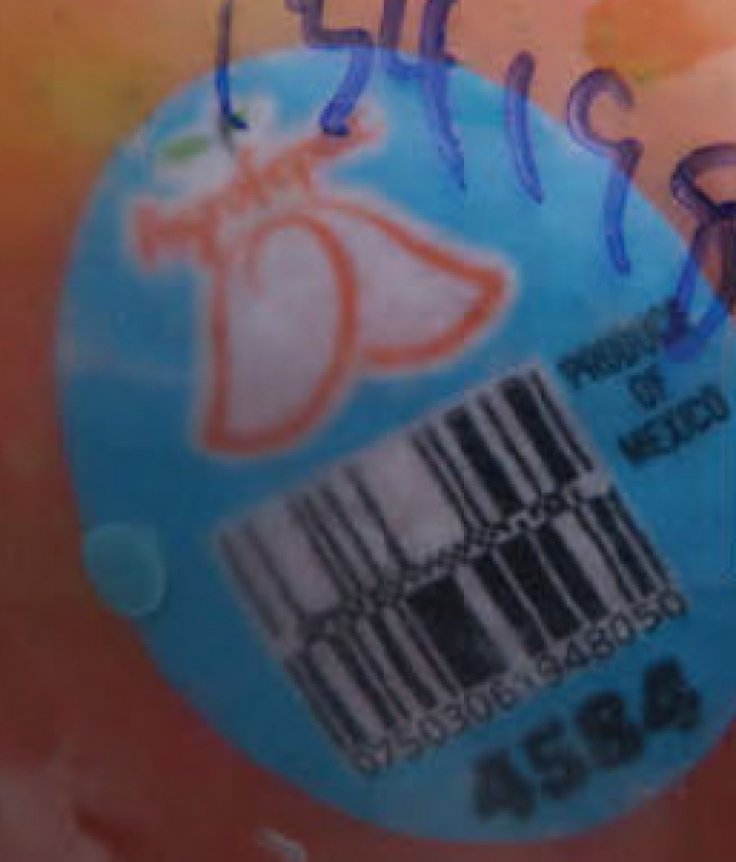 A close-up of a vial showing its blue label and barcode, with handwritten markings visible on the packaging. A close-up of a vial showing its blue label and barcode, with handwritten markings visible on the packaging.